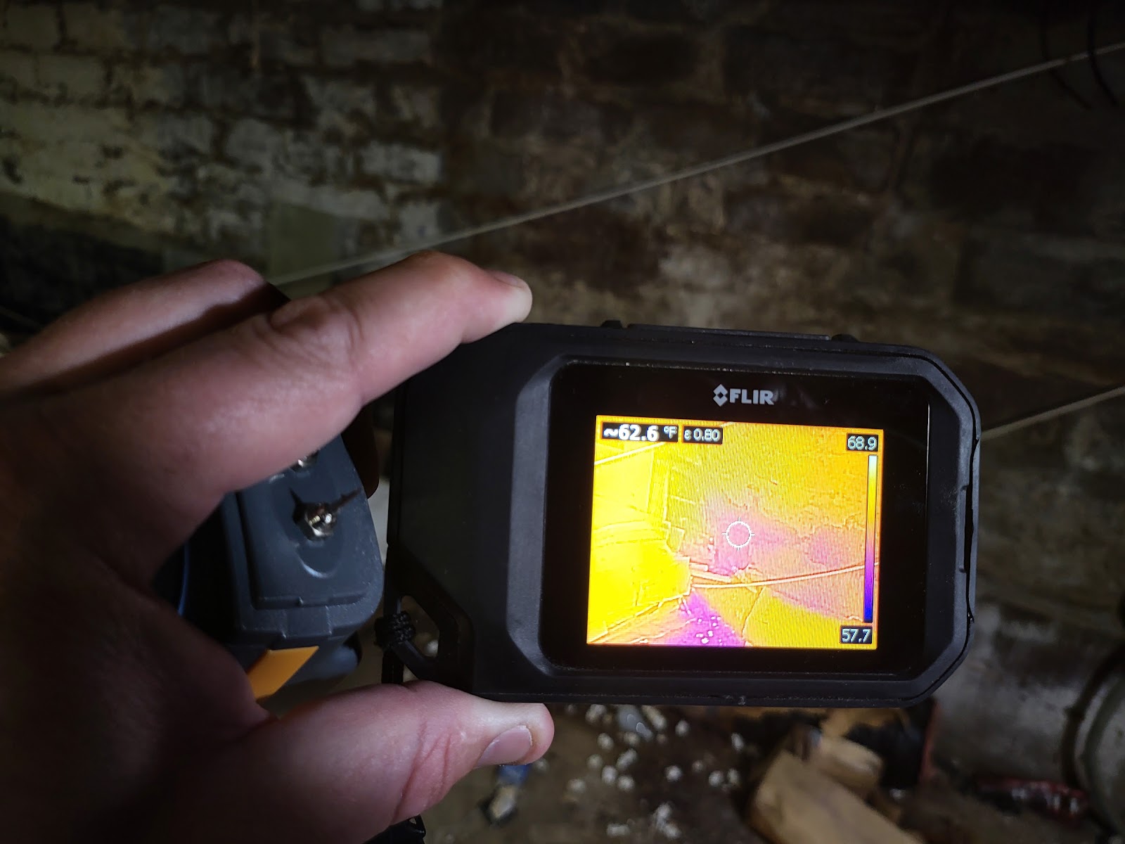 Thermal imaging camera showing heat signatures during crawlspace water damage inspection in Bloomington Indiana