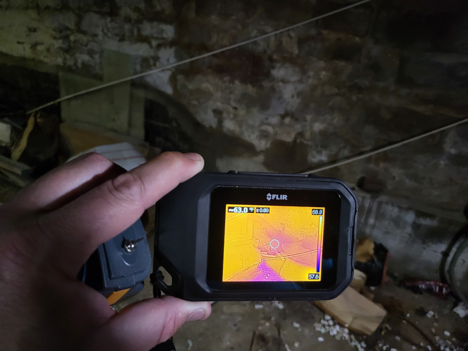 Water Pro Inc technician using thermal imaging camera during initial water damage assessment in Bloomington Indiana